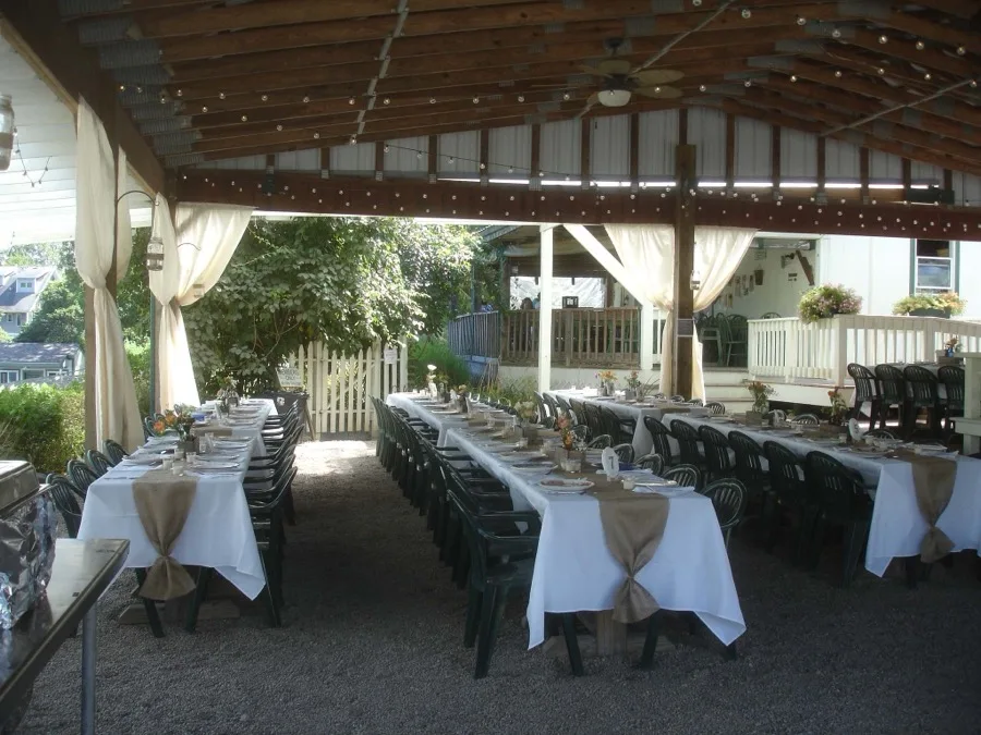 An outdoor wedding reception set up under the farm's covered pavilion